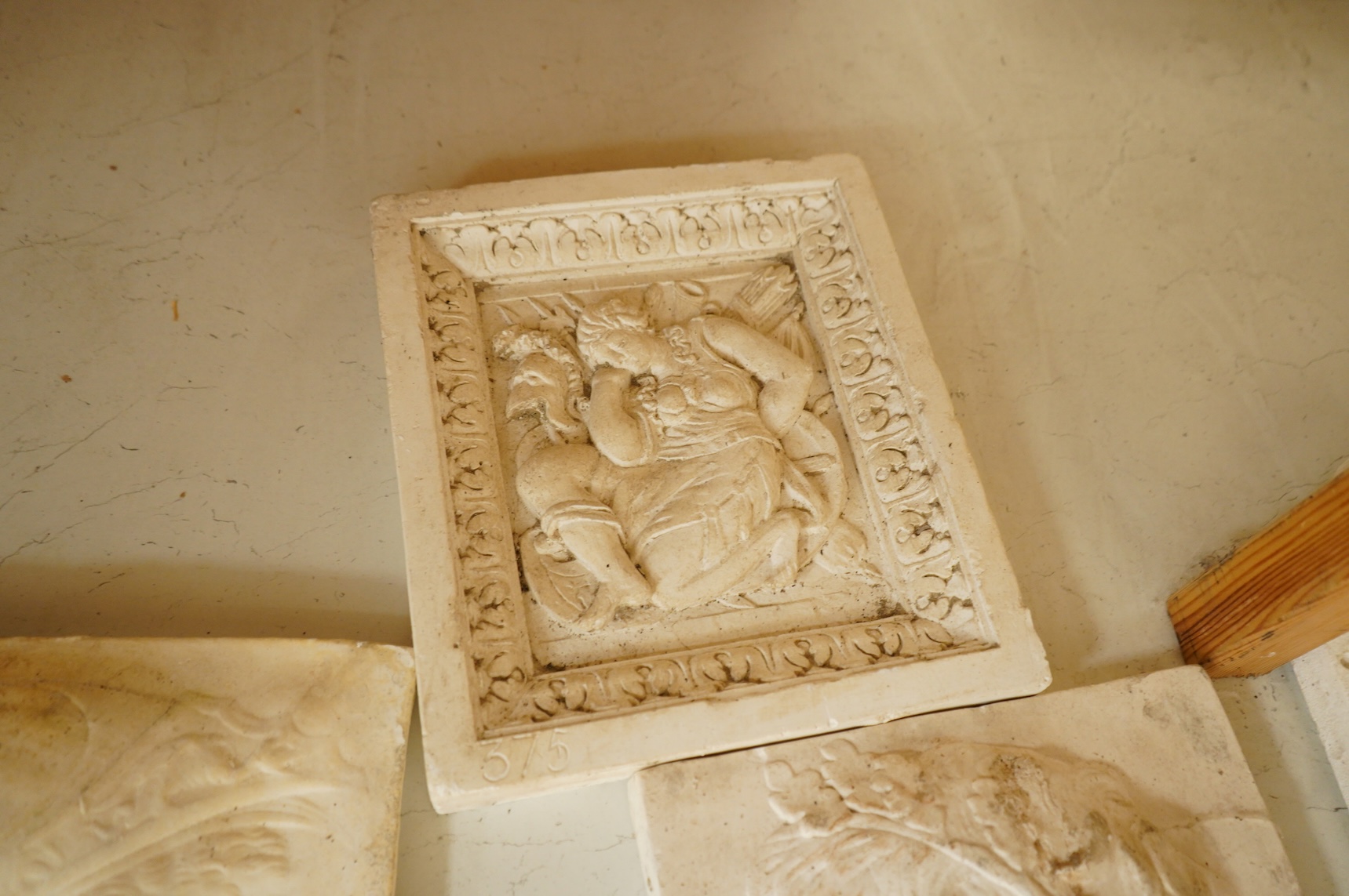 A collection of plaster-cast relief panels to include classical busts and foliage, largest 47cm high